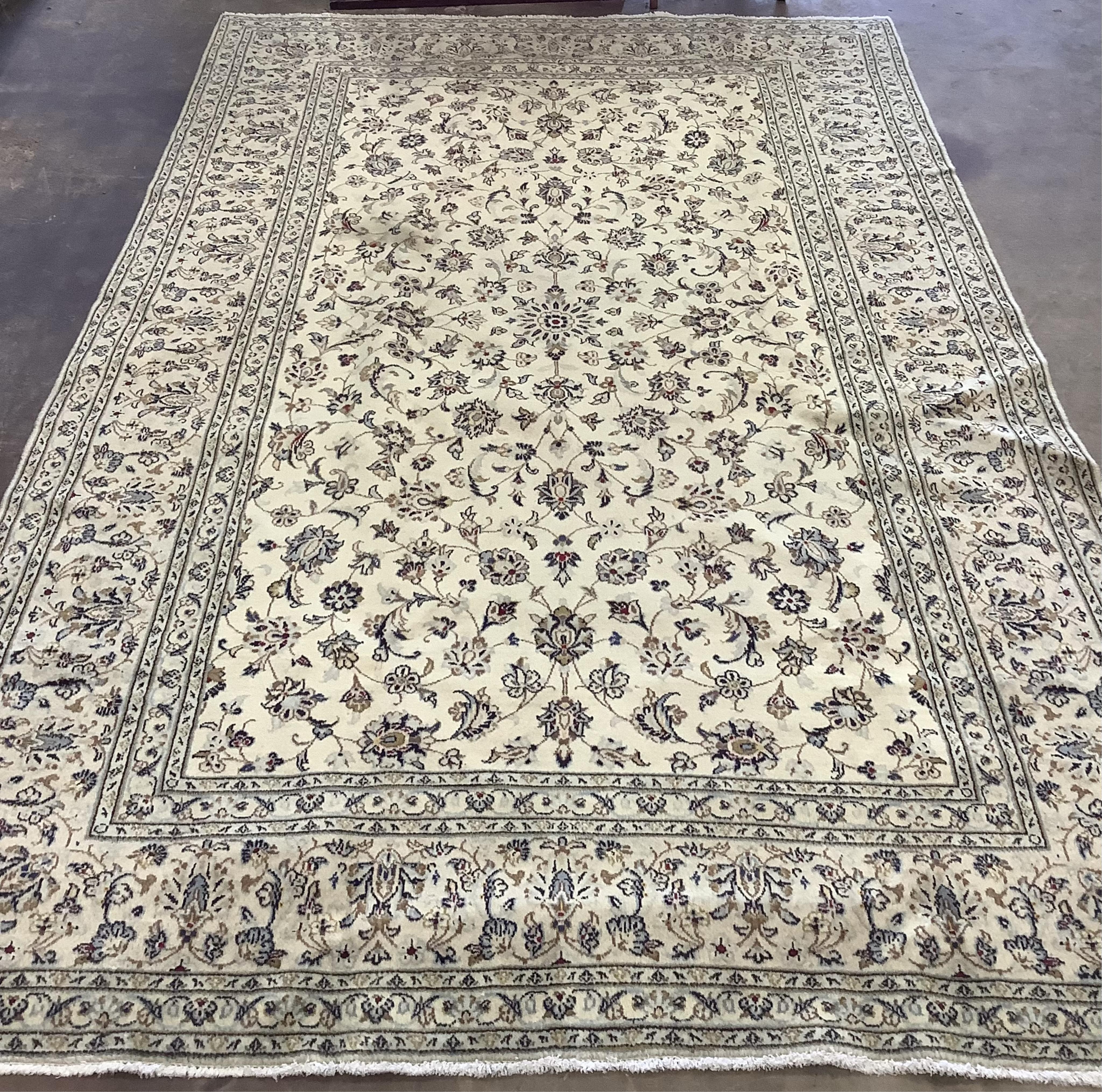 An ivory ground Kashan carpet, 305 x 196. Condition - good